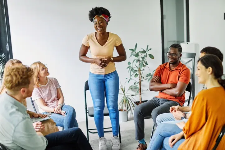 A facilitator leading a supportive community circle